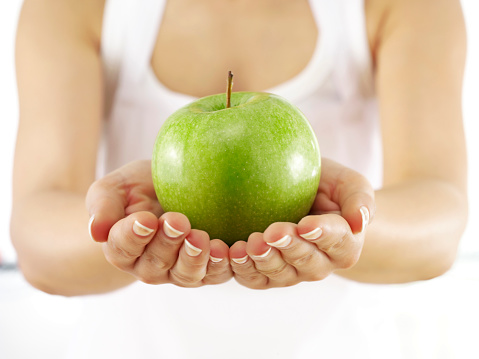 Woman holding an organic apple