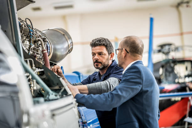 istock Helicopter hangar worker chatting with businessman 1444003839