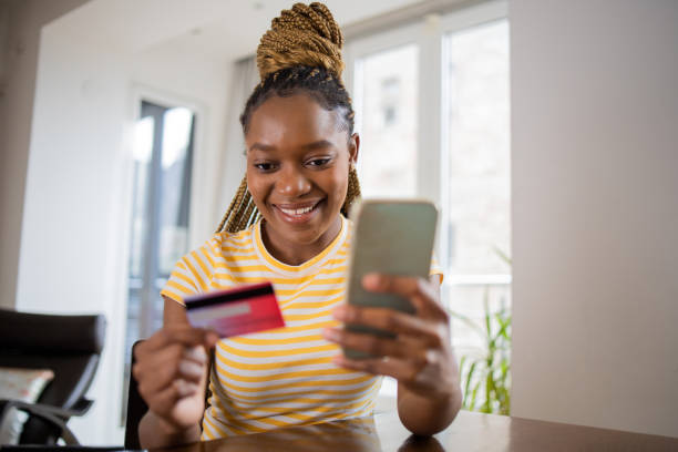 istock Cheerful  woman doing online shopping 1444004956