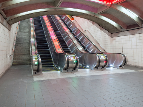 Wide angle shot of escalators in a subway underground tunnel