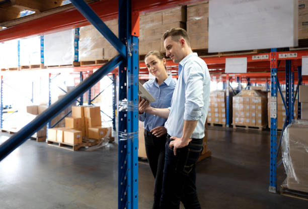 istock Storehouse supervisor worker and logistic engineer standing together at storage room. 1444015875