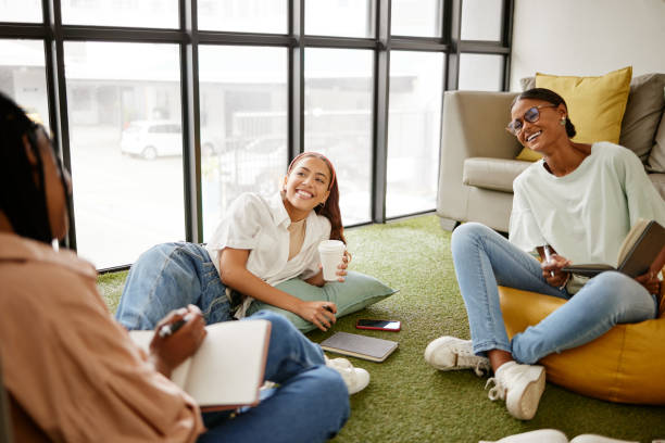 istock Writing, studying and collaboration student friends in university lounge for a group project, teamwork and planning schedule. Young women relax with coffee and brainstorming ideas and time management 1444021610