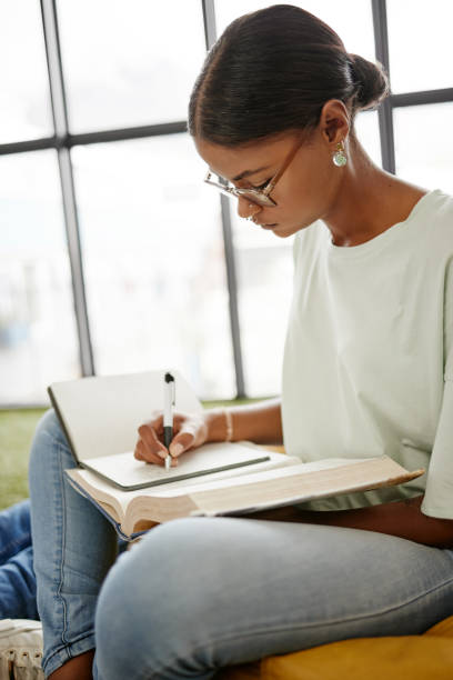 istock University student woman writing notebook, reading research and learning for education, knowledge and project at campus in Colombia. College youth study textbook, exam notes and school library books 1444021680