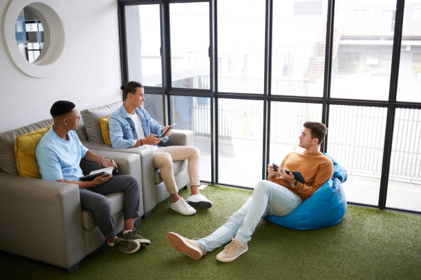 istock Teamwork, creative meeting or employees collaboration, talking and brainstorming ideas for their business. Startup company management and students planning, strategy or conversation for group project 1444021750