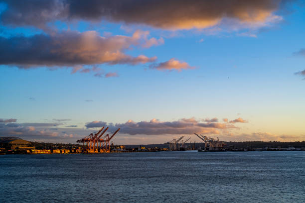 shipping container pier during a puget sound cloudy autumn sunset - water tranquil scene puget sound cloudscape imagens e fotografias de stock