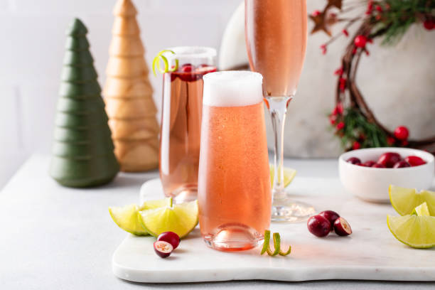 Christmas mimosa with cranberry juice and lime stock photo