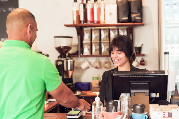 istock Man making contactless payment  at cafe counter. 1444027440