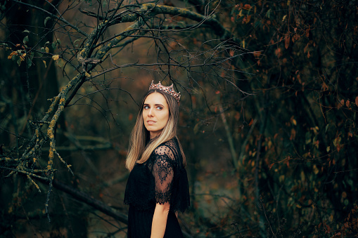 Gorgeous dark princess standing alone in the forest