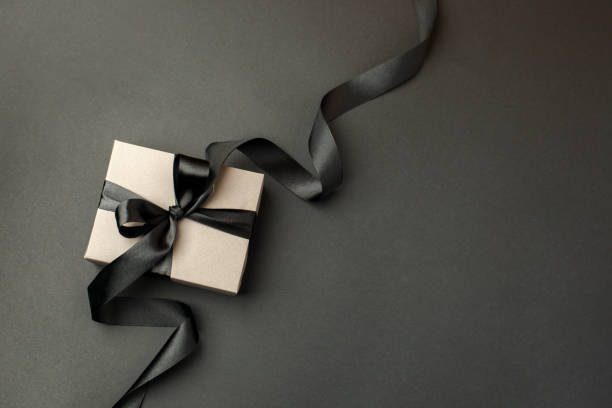 istock Craft gift box on a dark background, decorated with a textured bow, creating a romantic luxury atmosphere. For birthday, anniversary presents, gift post cards, banner, flyer, invitation, voucher 1444030983