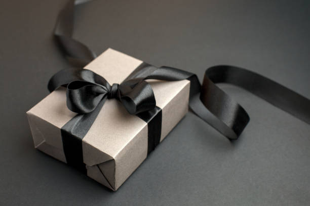 istock Craft gift box on a dark background, decorated with a textured bow, creating a romantic luxury atmosphere. For birthday, anniversary presents, gift post cards, banner, flyer, invitation, voucher 1444030993