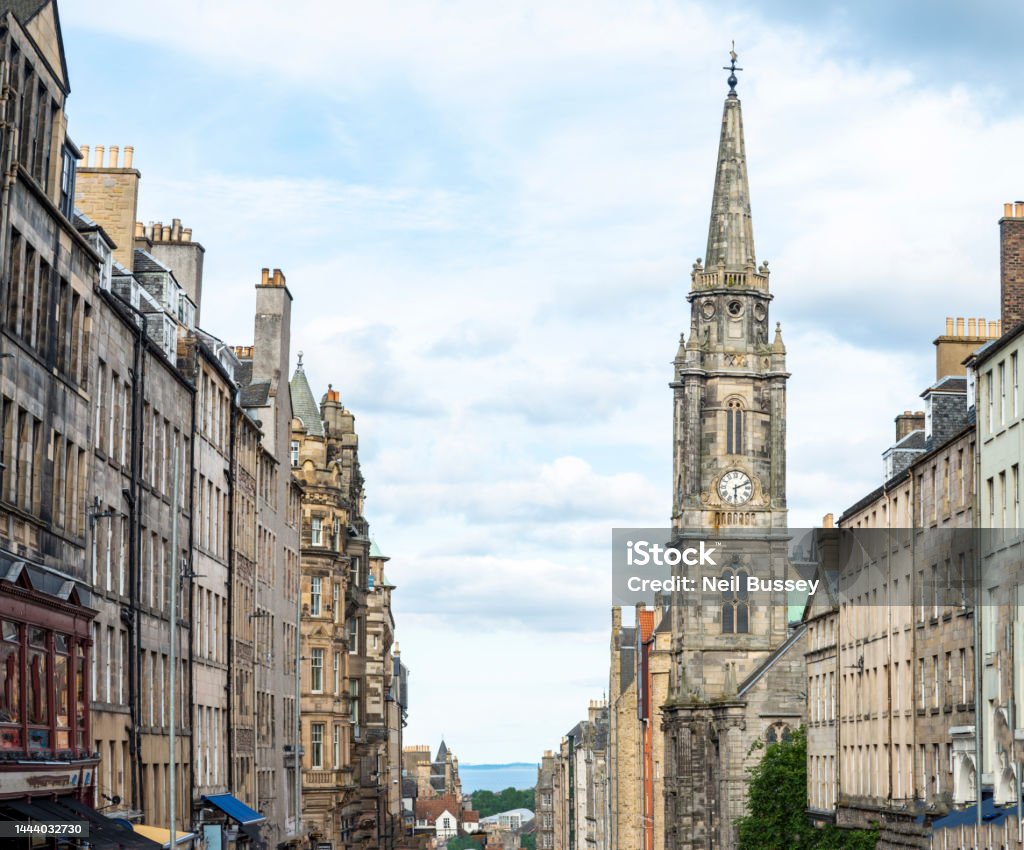 Edinburgh Old Town and Royal Mile,looking east,Scotland,UK.s View down Edinburgh High Street, towards the sea and Firth of Forth river,the Old town georgian buildings,in summertime,blue sky,clock tower of former church Edinburgh - Scotland Stock Photo