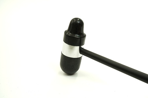 Image showing a black reflex hammer for osteoarthritis examination on a white background, isolated.