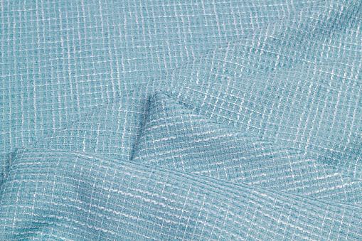 Boucle suiting fabric background texture. Blue color of the season