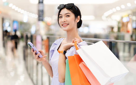 happy Asian woman shopping at mall