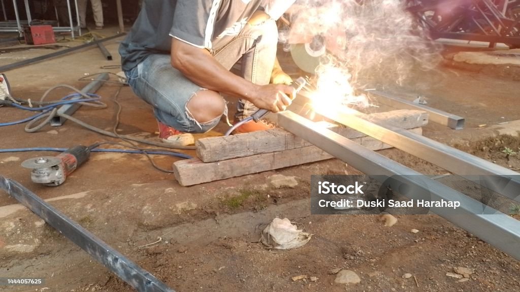 Sparks of steel welder work at factory Adult Stock Photo