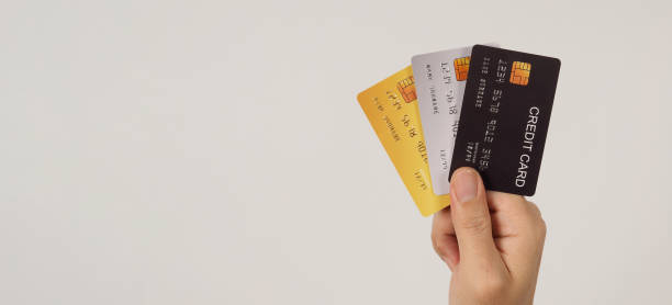 istock Hand is hold three credit cards on white background. 1444058568