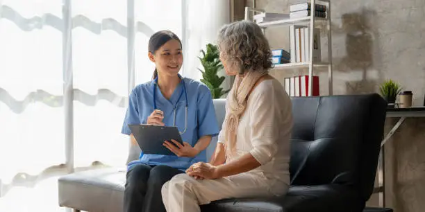 Photo of Home healthcare nurse, physical therapy with senior adult woman at home