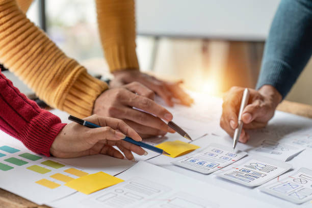 istock Group of ux developer and ui designer brainstorming about app interface design at modern office. Creative digital development agency 1444063477