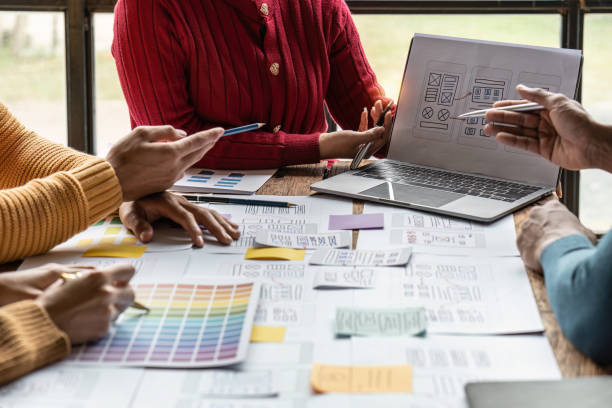 istock Group of ux developer and ui designer brainstorming about app interface design at modern office. Creative digital development agency 1444063513