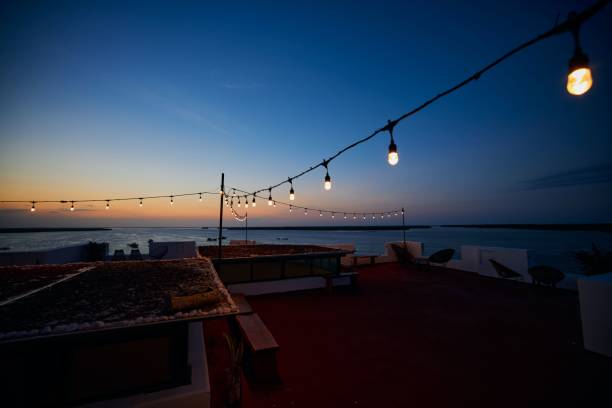 istock Open-air cafe with a sea view and lights at sunset 1444064578