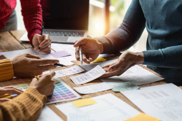 istock Group of ux developer and ui designer brainstorming about app interface design at modern office. Creative digital development agency 1444064659