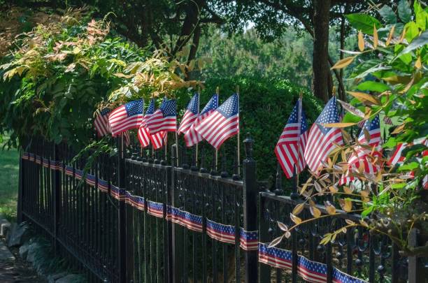 istock Rows of small American flags on a fence 1444066635