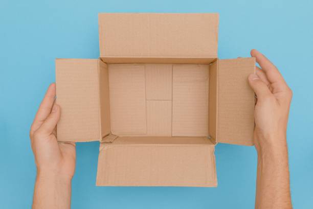 istock Male hands presenting an opened carton package without content by touching the side wings of the box 1444067755