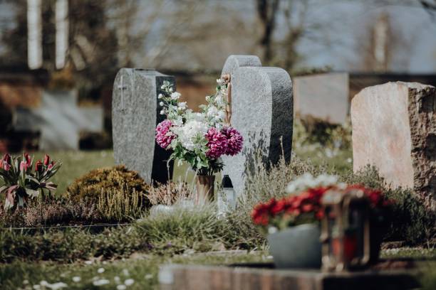 istock View of grave stones with flowers at graveyard 1444067941