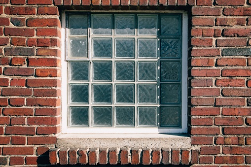 A window on a red brick wall at the Brickworks  Factory in Toronto.