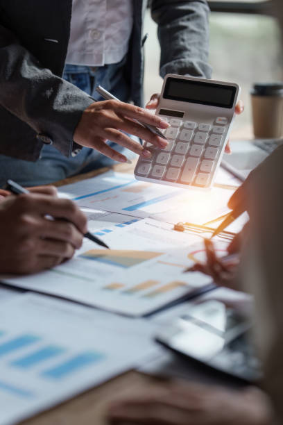 Business people brainstorming data target financial on financial document paperwork. business finance and discuss concept