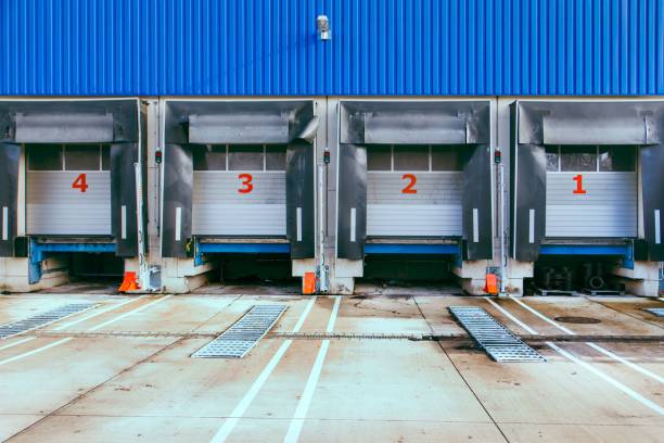 istock Closeup of loading ramps with numbers on closed shutter doors 1444068553