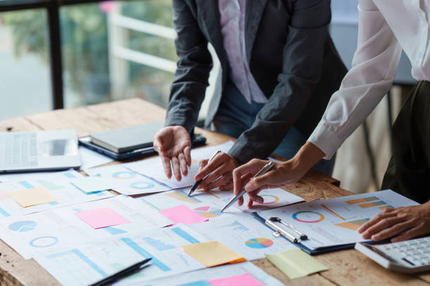 Business people brainstorming data target financial on financial document paperwork. business finance and discuss concept