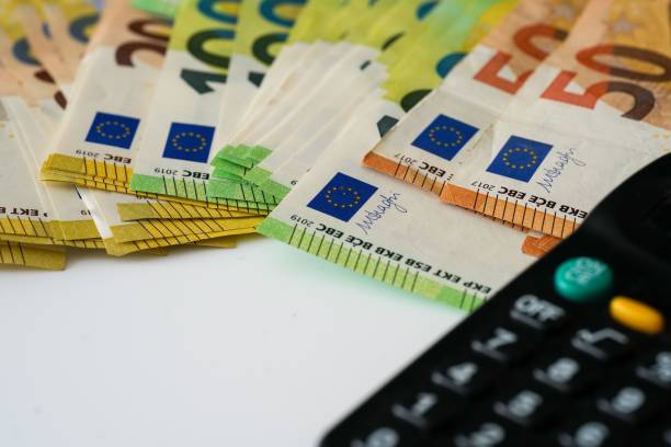 istock Euro banknotes with the black calculator on white background, close-up 1444069454