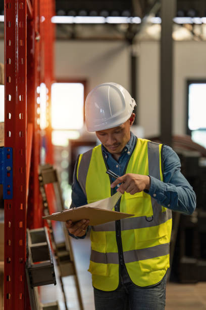 istock Working at warehouse. Male warehouse worker checking in storage department. Employee organizing goods distribution to the market. 1444071427