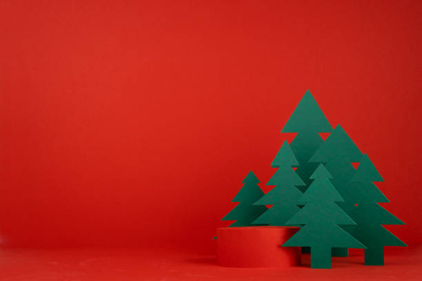 istock Christmas background with one cylinder podium and scene with 3d rendering for presentation gifts, cosmetics, goods in red color with green spruce forest. New year celebration template for advertising. 1444071976