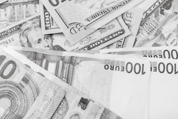 istock Grayscale shot of stack of euro and dollar banknotes 1444072937