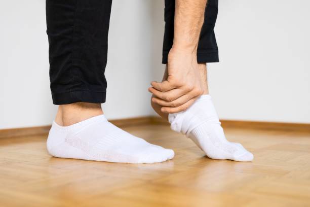 istock Person putting on white ankle socks 1444073060
