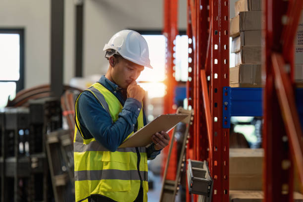 istock Working at warehouse. Male warehouse worker checking in storage department. Employee organizing goods distribution to the market. 1444073253