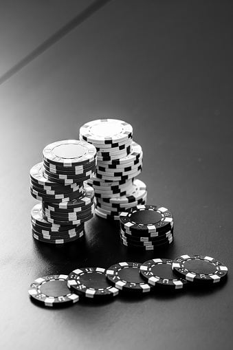 A vertical grayscale shot of stacks of poker chips