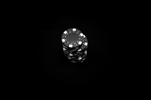 A grayscale top shot of a stack of poker chips