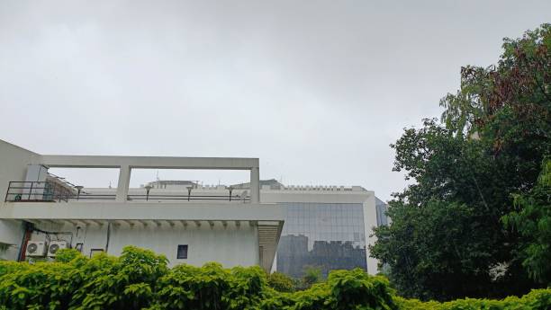 istock White modern buildings behind the trees and the bushes 1444074603