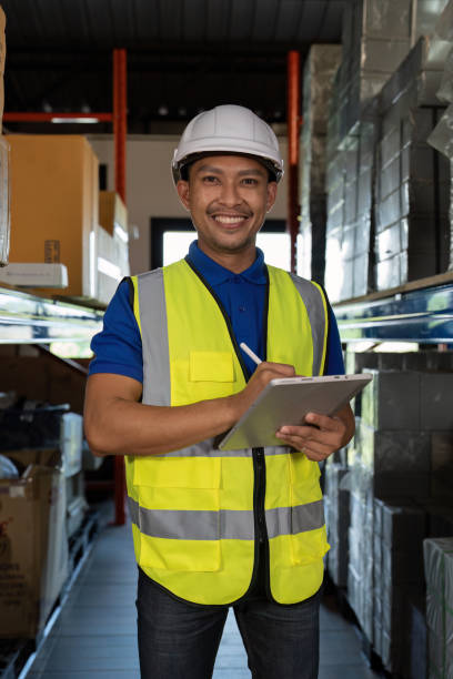 Working at warehouse. Male warehouse worker checking in storage department. Employee organizing goods distribution to the market.