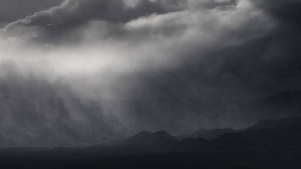 istock Dramatic shot of thick clouds over mountain silhouettes on a gloomy day 1444074901
