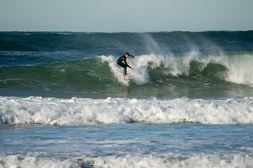 man surfing waves on bali beach