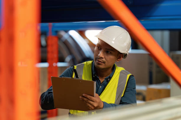istock Working at warehouse. Male warehouse worker checking in storage department. Employee organizing goods distribution to the market. 1444074977