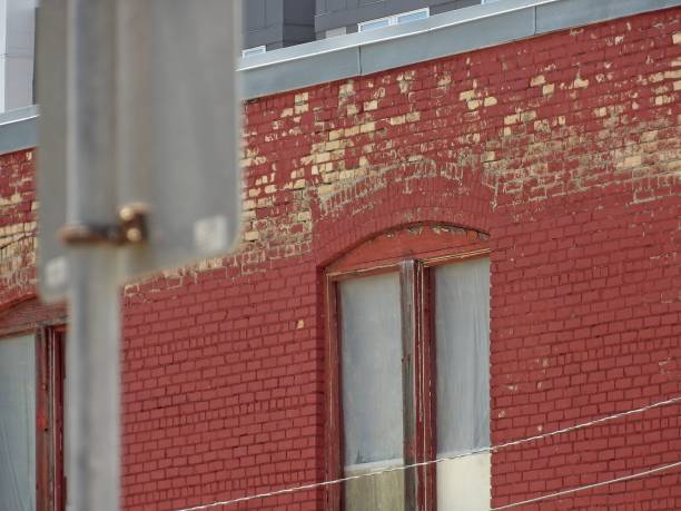 istock Exterior view of old brick building with weathered wall 1444075040