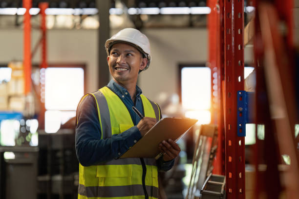 Working at warehouse. Male warehouse worker checking in storage department. Employee organizing goods distribution to the market.