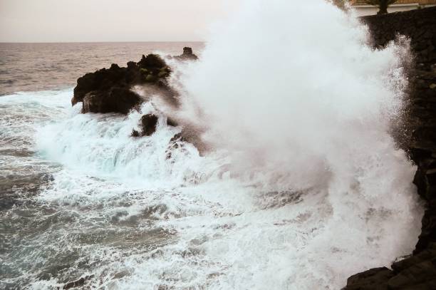 istock Shot of a strong wave hitting a cliff on the coast side 1444077177
