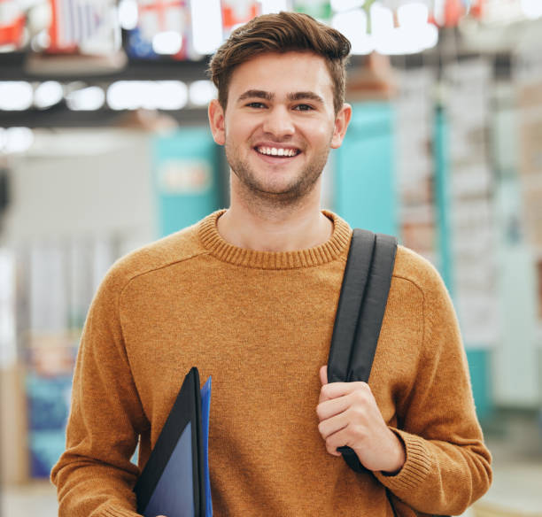 istock College, study and education student man portrait with back to school backpack and portfolio in a classroom or university campus. Learning person with motivation, goal and knowledge for a scholarship 1444077739