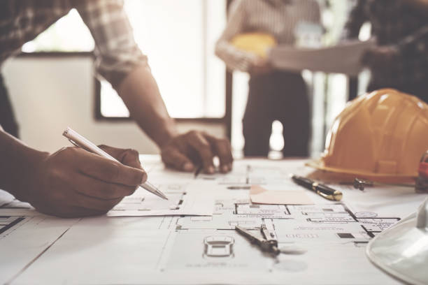 Professional architect designer structural engineer team colleagues discussing building plan design project Professional architect designer structural engineer team colleagues discussing building plan design project. office buddies stock pictures, royalty-free photos & images
